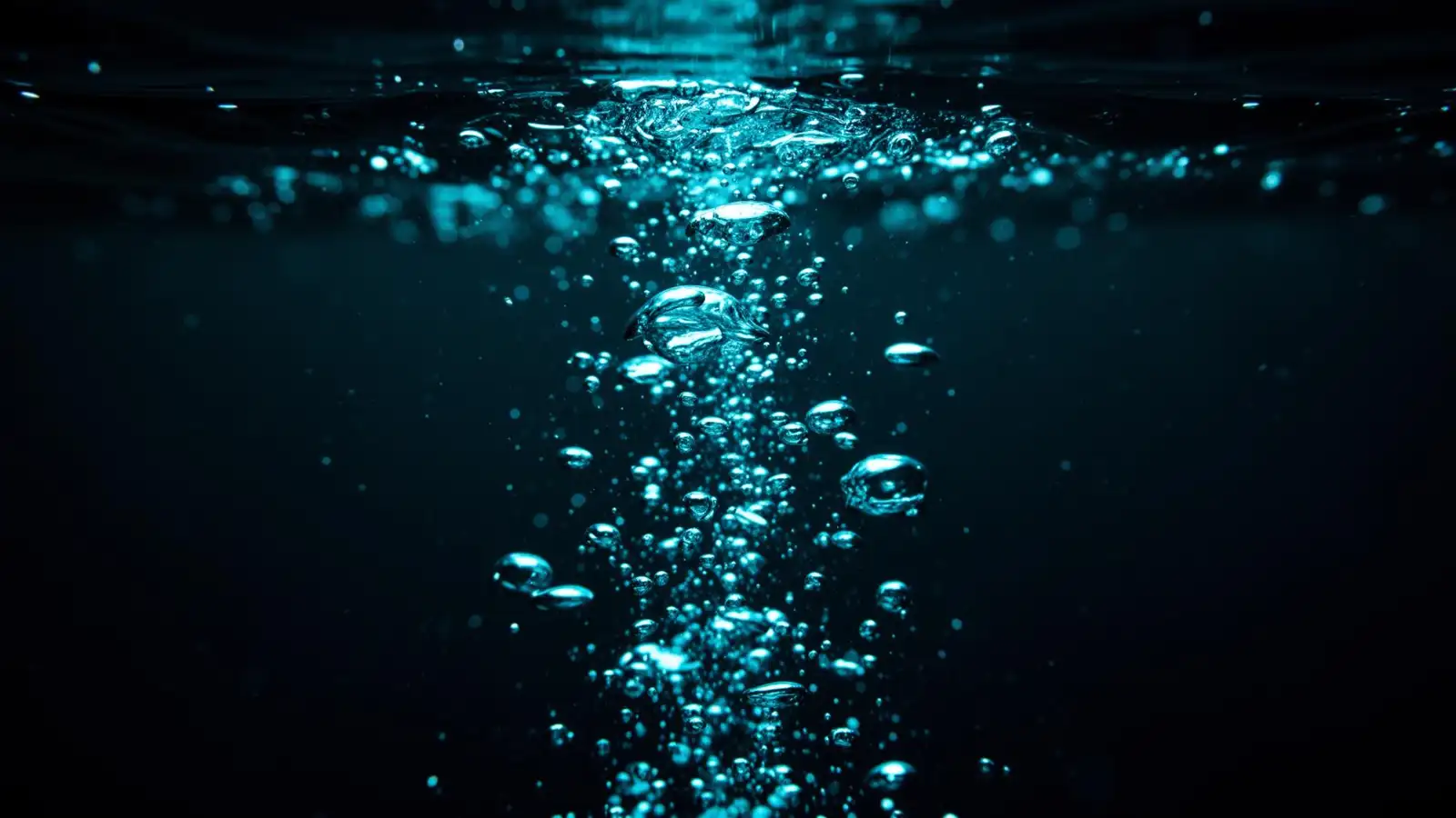 Fine bubbles rising through dark water